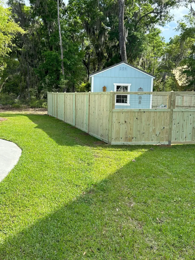 Wood privacy fence around a Beaufort Fence customer’s backyard
