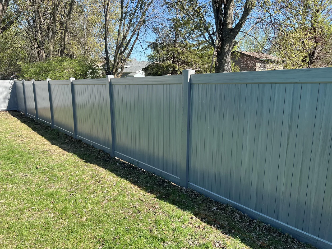 Gray vinyl privacy fence, shared-library reference
